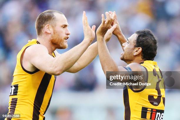 Jarryd Roughed of the Hawks and Cyril Rioli celebrate a goal during the round two AFL match between the Geelong Cats and the Hawthorn Hawks at...