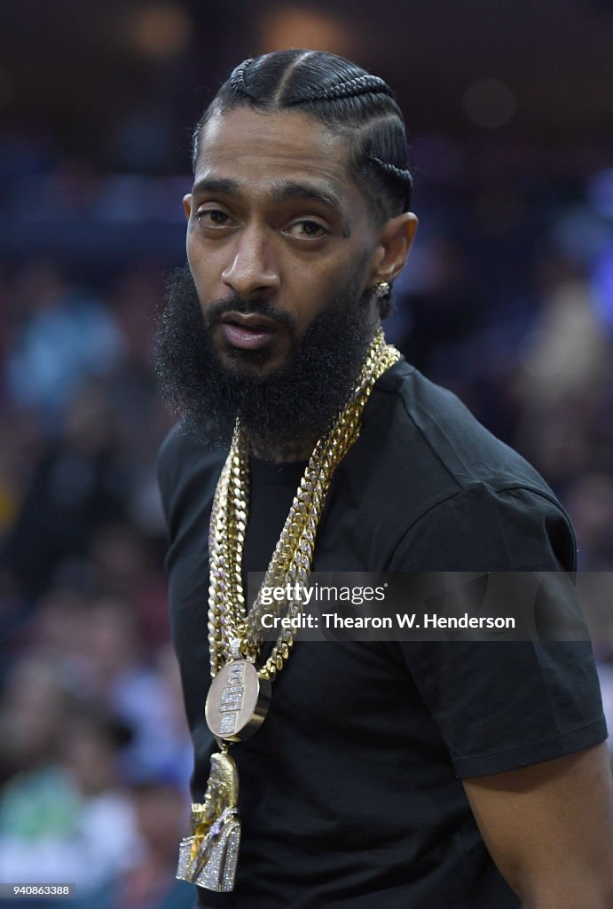 Cg Rapper Rapper Nipsey Hussle sitting at courtside looks on during an NBA ...