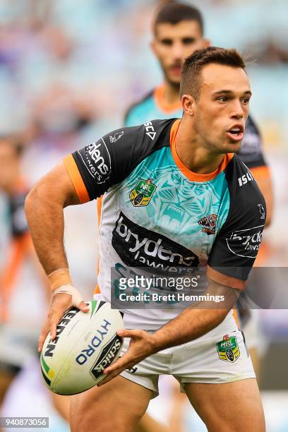 Luke Brooks of the Tigers looks to pass the ball during the round four NRL match between the Wests Tigers and the Parramatta Eels at ANZ Stadium on...