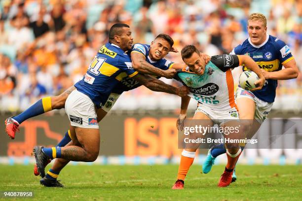 Luke Brooks of the Tigers is tackled during the round four NRL match between the Wests Tigers and the Parramatta Eels at ANZ Stadium on April 2, 2018...