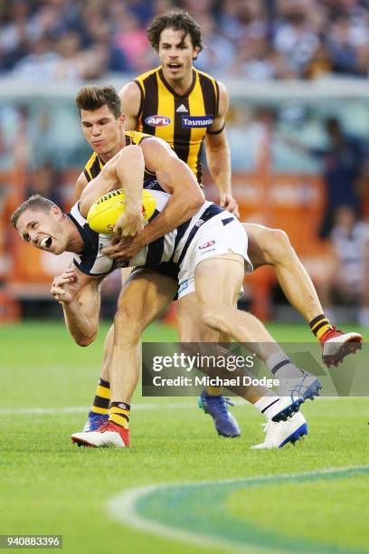 Jaeger O'Meara of the Hawks tackles high Joel Selwood of the Cats during the round two AFL match between the Geelong Cats and the Hawthorn Hawks at...