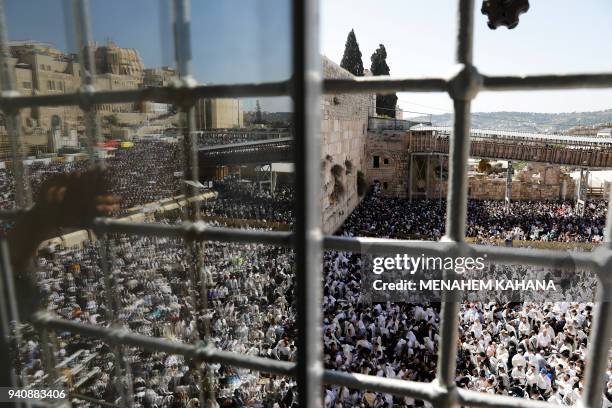 Jewish priests and religious men wearing "Talit" take part in the Cohanim prayer during the Passover holiday at the Western Wall in the Old City of...