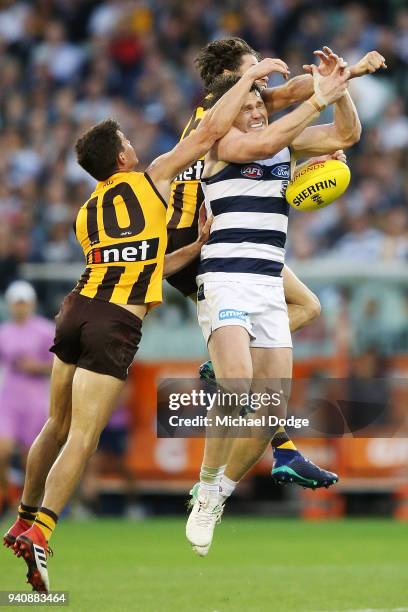 Patrick Dangerfield of the Cats compete for the ball against Jaeger O'Meara of the Hawks and Isaac Smith of the Hawks during the round two AFL match...