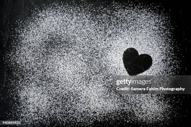 heart shape formed by powdered sugar on slate - powdered sugar stock pictures, royalty-free photos & images