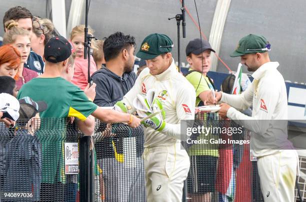 Tim Paine and Nathan Lyon sign autographs for supporters as they leave the field due to deteriorated lighting during day 4 of the 4th Sunfoil Test...