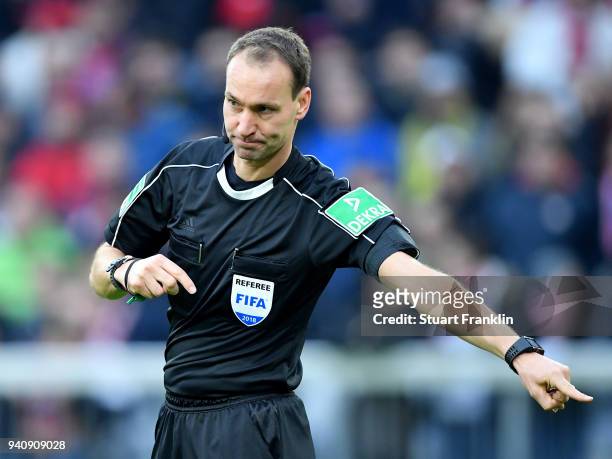Referee Bastian Dankert gestures during the Bundesliga match between FC Bayern Muenchen and Borussia Dortmund at Allianz Arena on March 31, 2018 in...