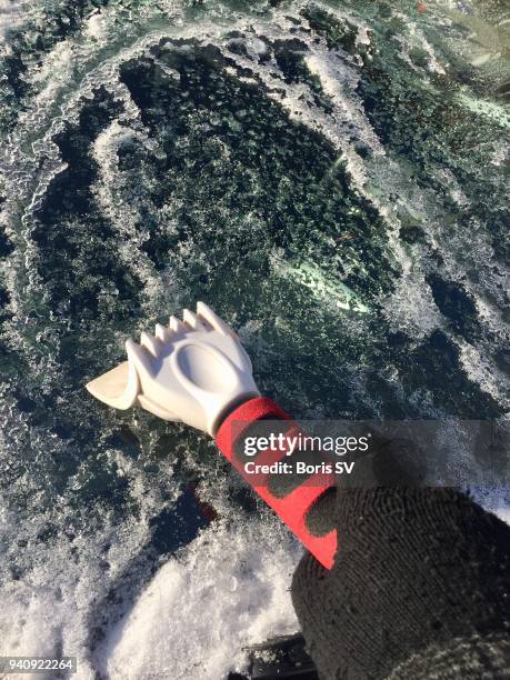 scratching ice from windshield - eiskratzer stock-fotos und bilder