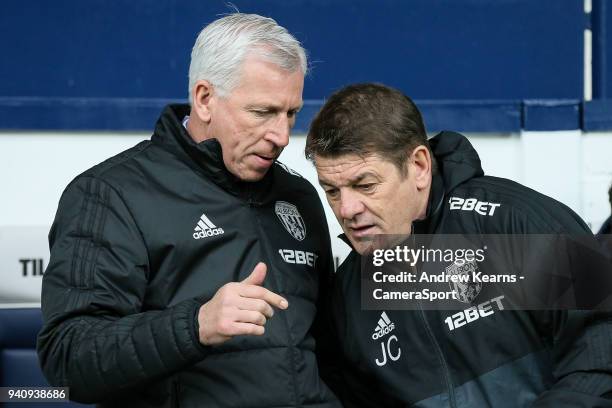 West Bromwich Albion's manager Alan Pardew chats to first team coach John Carver during the Premier League match between West Bromwich Albion and...