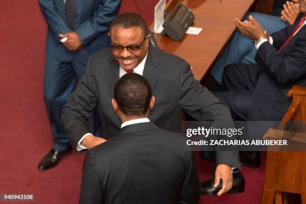 Abiy Ahmed, the newly elected Prime Minister of Ethiopia, is being congratulated by the outgoing Prime Minister, Hailemariam Desalegn , after the...