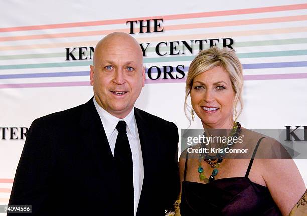 Cal Ripken Jr and Kelly Ripken pose for photographers on the red carpet before the 32nd Kennedy Center Honors at Kennedy Center Hall of States on...