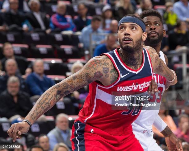 Mike Scott of the Washington Wizards battles for position with James Ennis III of the Detroit Pistons during an NBA game at Little Caesars Arena on...