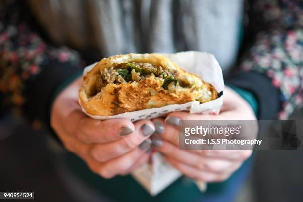 street food: person holding a 福州世祖胡椒饼 aka fu zhou hot pepper bun at raohe night market - taipei stock pictures, royalty-free photos & images