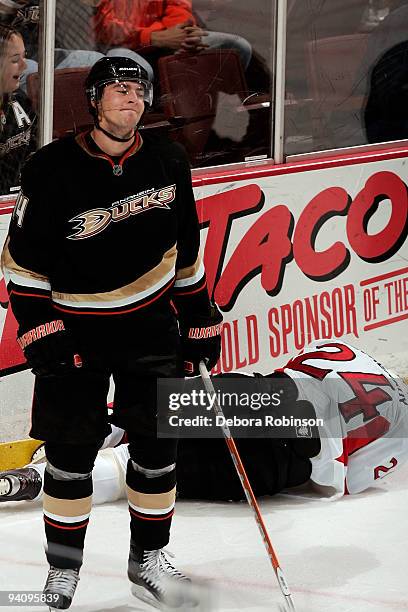 Anton Volchenkov of the Ottawa Senators falls to the ice after a hit from Joffrey Lupul of the Anaheim Ducks during the game on December 6, 2009 at...