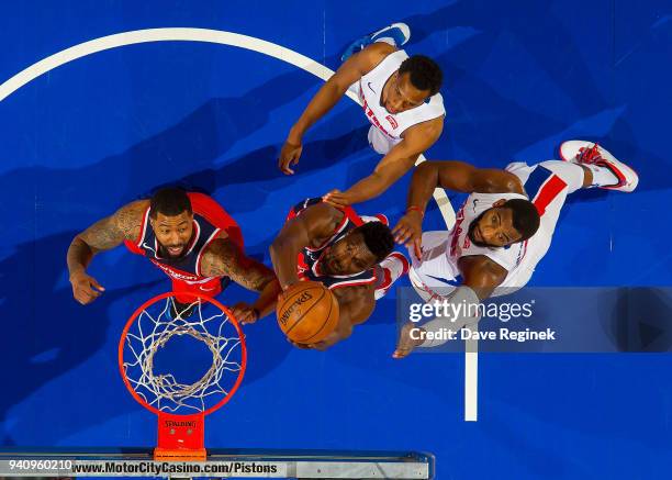 Ian Mahinmi of the Washington Wizards grabs the rebound in front of Andre Drummond of the Detroit Pistons during an NBA game at Little Caesars Arena...