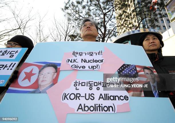 South Korean anti-war activists hold a placard showing portraits of US President Barack Obama and North Korean leader Kim Jong-Il during a...