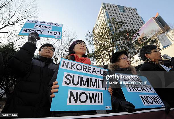 South Korean anti-war activists hold placards during a demonstration demanding a peace treaty instead of an armistice in the Korean Peninsula, in...