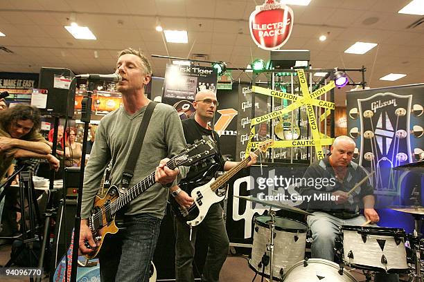 Musician Todd Lewis, Doni Blair and Mark Reznicek of the Toadies perform at Guitar Center to promote the new Gibson Dusk Tiger robot guitar on...