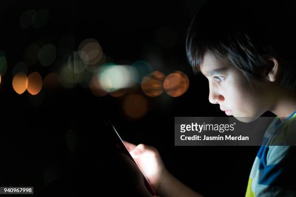 phone as source of light - child nervous stock-fotos und bilder