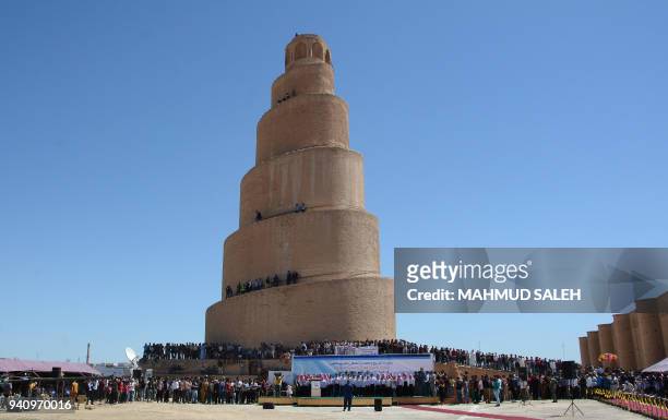 General view shows Iraqis gathered around the al-Malwuaiya Tower , Spiral Minaret, at the remains of the ancient city of Samarra, on April 2 during...