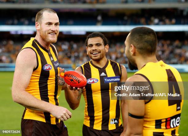 Jarryd Roughead, Cyril Rioli and Jarman Impey of the Hawks celebrate during the 2018 AFL round 02 match between the Geelong Cats and the Hawthorn...