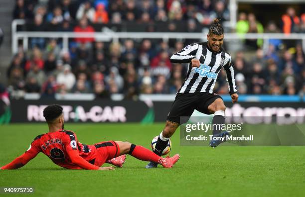 DeAndre Yedlin of Newcastle United is tackled by Elias Kachunga of Huddersfield Town during the Premier League match between Newcastle United and...