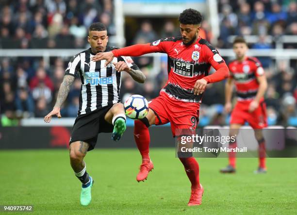 Kenedy of Newcastle United challenges Elias Kachunga of Huddersfield Town during the Premier League match between Newcastle United and Huddersfield...