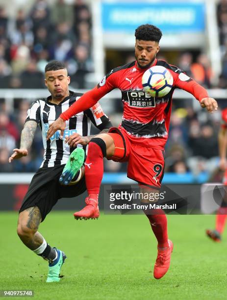 Kenedy of Newcastle United challenges Elias Kachunga of Huddersfield Town during the Premier League match between Newcastle United and Huddersfield...