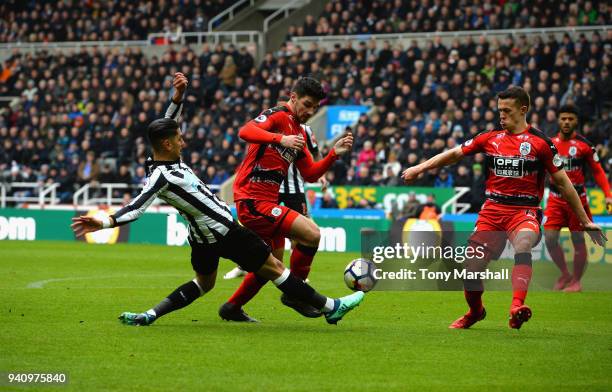 Ayoze Perez of Newcastle United tackles Christopher Schindler of Huddersfield Town during the Premier League match between Newcastle United and...