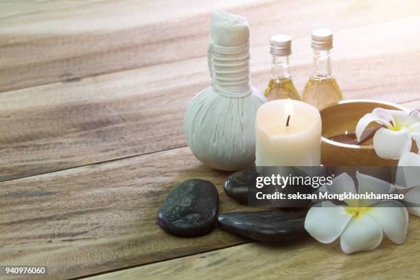 spa feet and hand thai massage compress balls, herbal ball on the wooden with treatments spa , summer day,thailand. healthy concept. - massage ball stock pictures, royalty-free photos & images