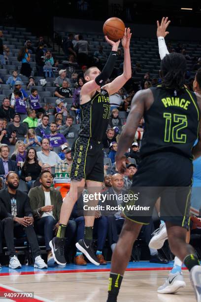 Mike Muscala of the Atlanta Hawks shoots a three pointer against the Sacramento Kings on March 22, 2018 at Golden 1 Center in Sacramento, California....