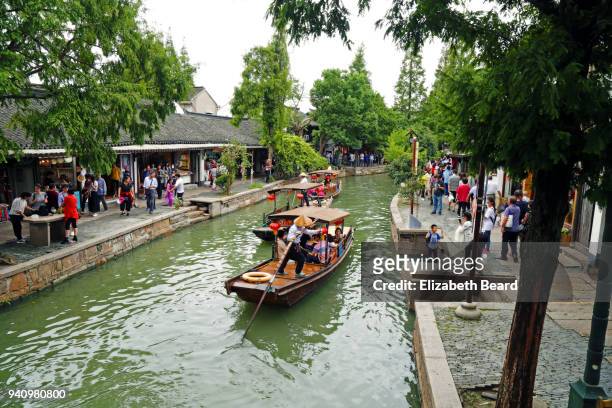 sampans being rowed through zhujiajiao water town, shanghai - zhujiajiao stock pictures, royalty-free photos & images