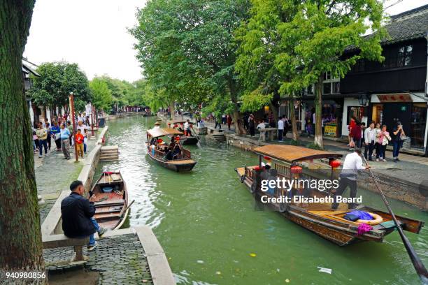 sampans being rowed through zhujiajiao water town, shanghai - zhujiajiao stock pictures, royalty-free photos & images