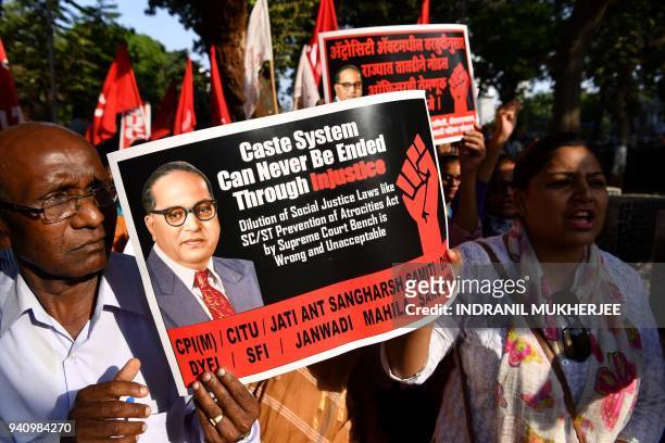 Indian members of the Scheduled Castes shout slogans during a protest against a Supreme Court order that allegedly diluted the Scheduled Castes and...