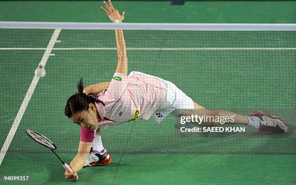 Wong Mew Choo of Malaysia stretches to reach a return to Yao Jie of the Netherlands in the first women's semi-final match at the Badminton World...