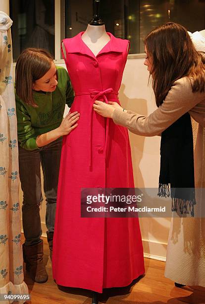 Givenchy fuchsia pink evening gown belonging to Audrey Hepburn's is adjusted by staff at The Kerry Taylor Auctions on December 4, 2009 in London....
