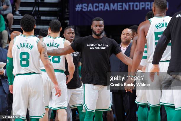 Kadeem Allen of the Boston Celtics high fives teammates during the game against the Sacramento Kings on March 25, 2018 at Golden 1 Center in...