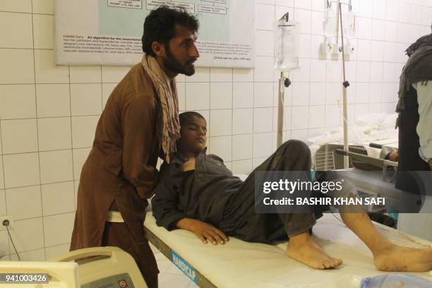 An Afghan resident is treated at a hospital following an airstrike in Kunduz on April 2, 2018. - An Afghan airstrike on a religious school in a...