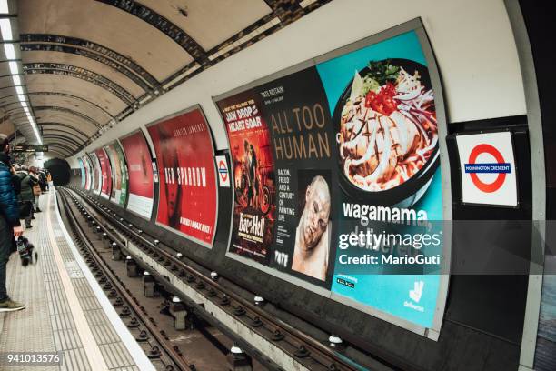 advertisements inside london underground - london billboard stock pictures, royalty-free photos & images