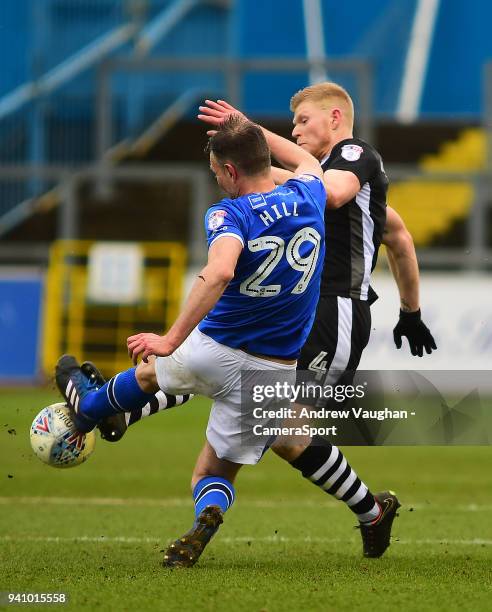 Lincoln City's Elliott Whitehouse vies for possession with Carlisle United's Clint Hill during the Sky Bet League Two match between Carlisle United...