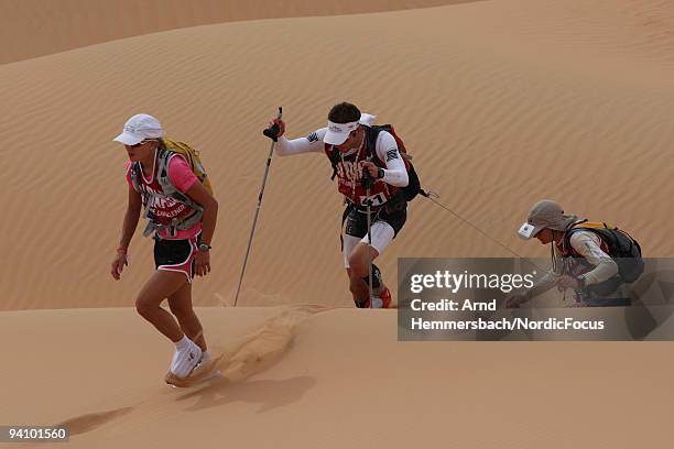 Elina Usher of New Zealand, Benjamin Rossmann of Germany and Andrea Huser of Switzerland fight against the dunes on December 6, 2009 in Abu Dhabi,...