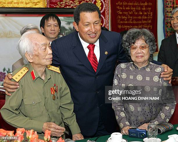 Visiting Venezuelean President Hugo Chavez poses with Vietnamese legendary general Vo Nguyen Giap and his wife Mrs. Ha at the general's house in...