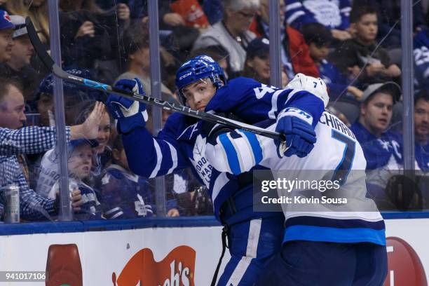 Ben Chiarot of the Winnipeg Jets ties up Tyler Bozak of the Toronto Maple Leafs along the boards during the second period at the Air Canada Centre on...