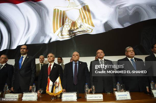 National Elections Authority chief Lasheen Ibrahim and Deputy Chief of the NEC Mahmoud al-Sherif stand for the national anthem during a press...
