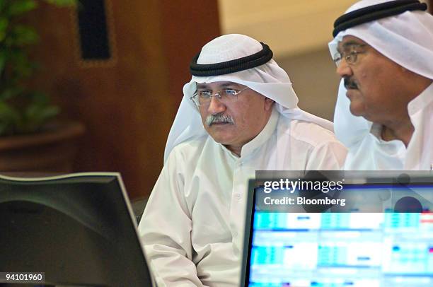 Investors use computers to monitor the share prices at the Dubai Financial Market, at the Dubai World Trade Centre, in Dubai, United Arab Emirates,...