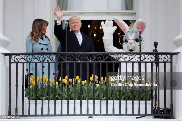 President Donald Trump and first lady Melania Trump walk out onto the Truman Balcony with a person in an Easter Bunny costume during the 140th annual...