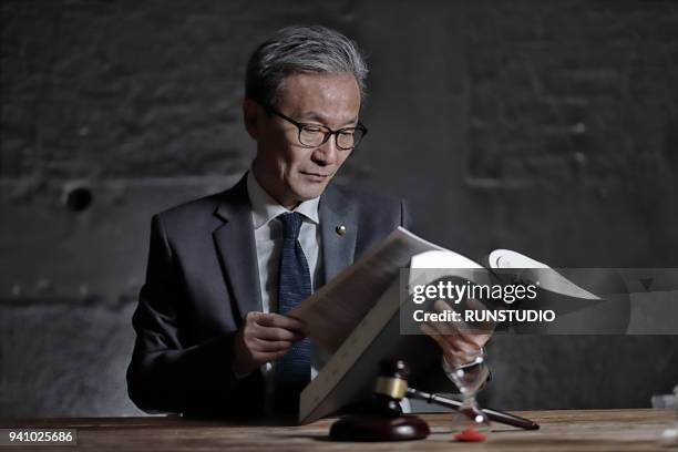 Lawyer Reading Law Book In Office High-Res Stock Photo - Getty Images