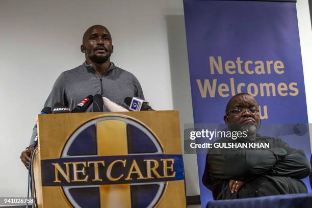 Grandson of Winnie Mandela, Zondwa Mandela, flanked by South Africa's African National Congress chairperson Gwede Mantashe speaks to the media at a...