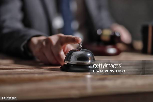 businessman ringing service bell - reception hotel photos et images de collection