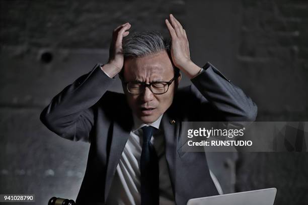 lawyer with headache - legal problems stock pictures, royalty-free photos & images