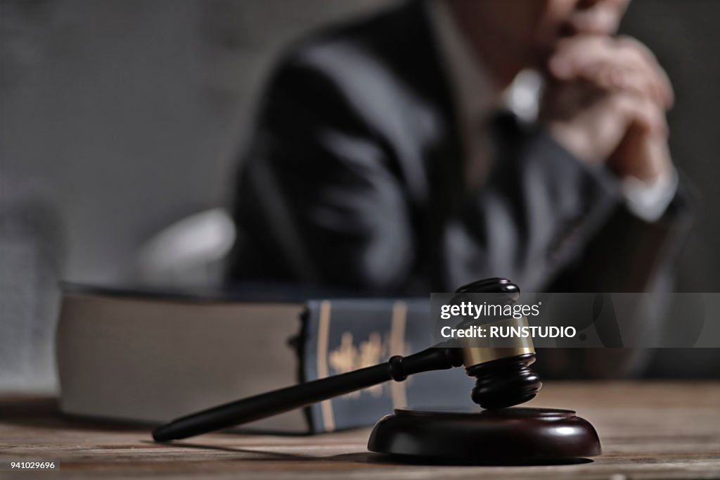 Gavel and law book in front of lawyer